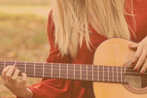 Woman playing acoustic guitar
