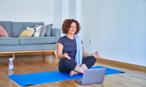 woman doing yoga online